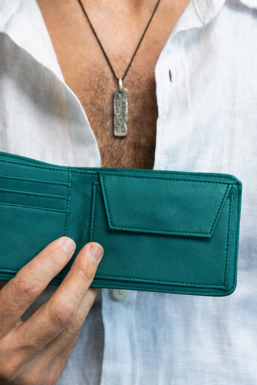 Vegan Mens wallet in teal made from cactus leather, in hand