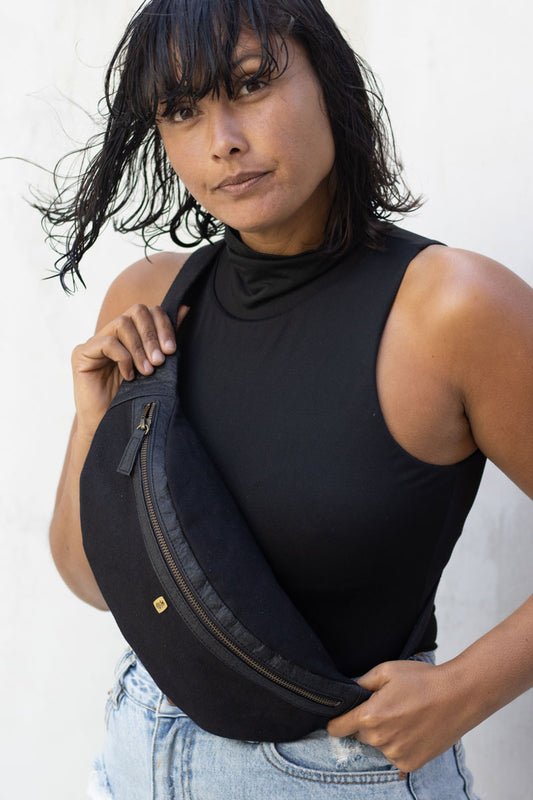 Vegan unisex black hip bag worn across the body