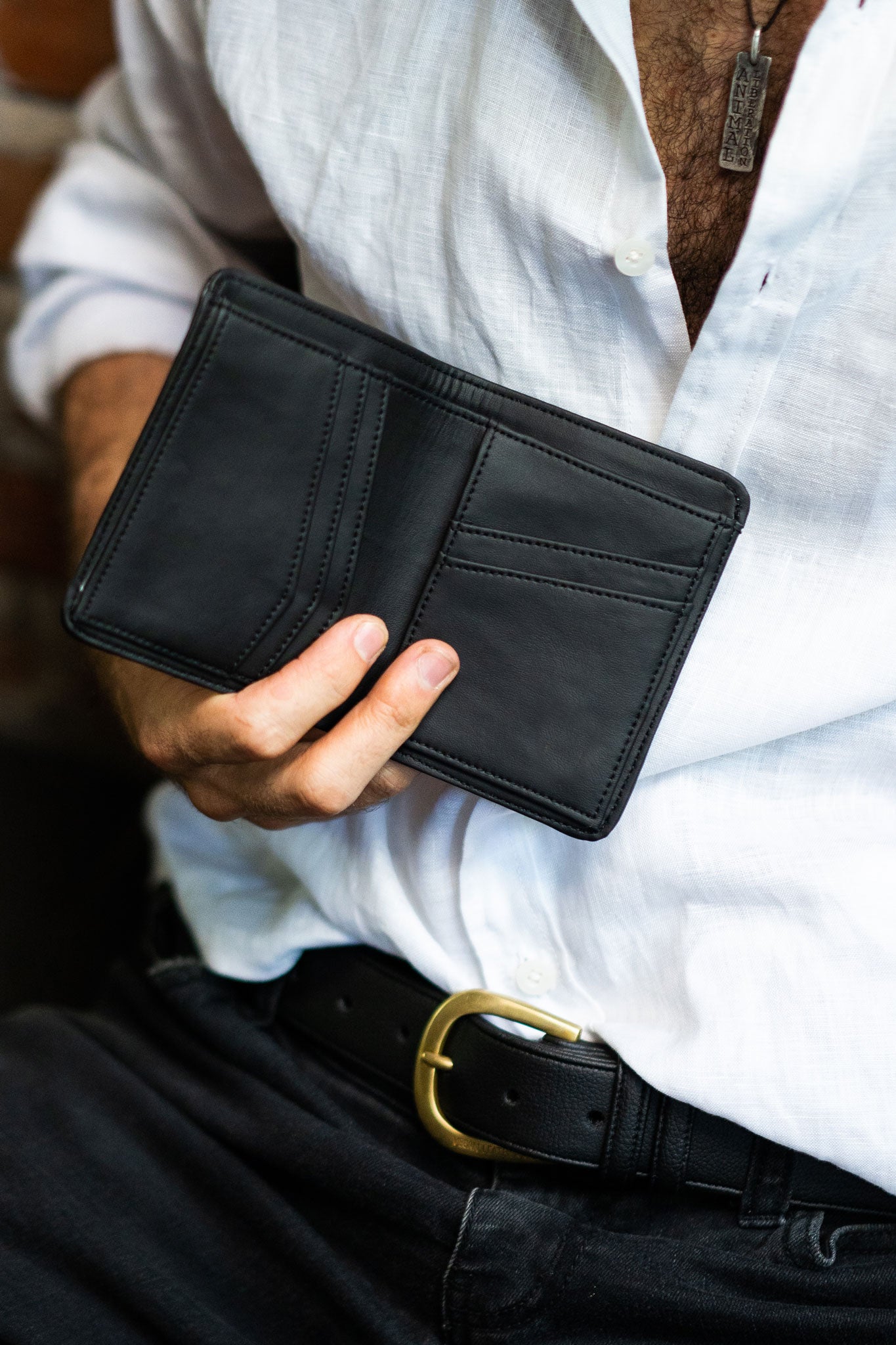 inside of desserto cactus leather wallet held by a man