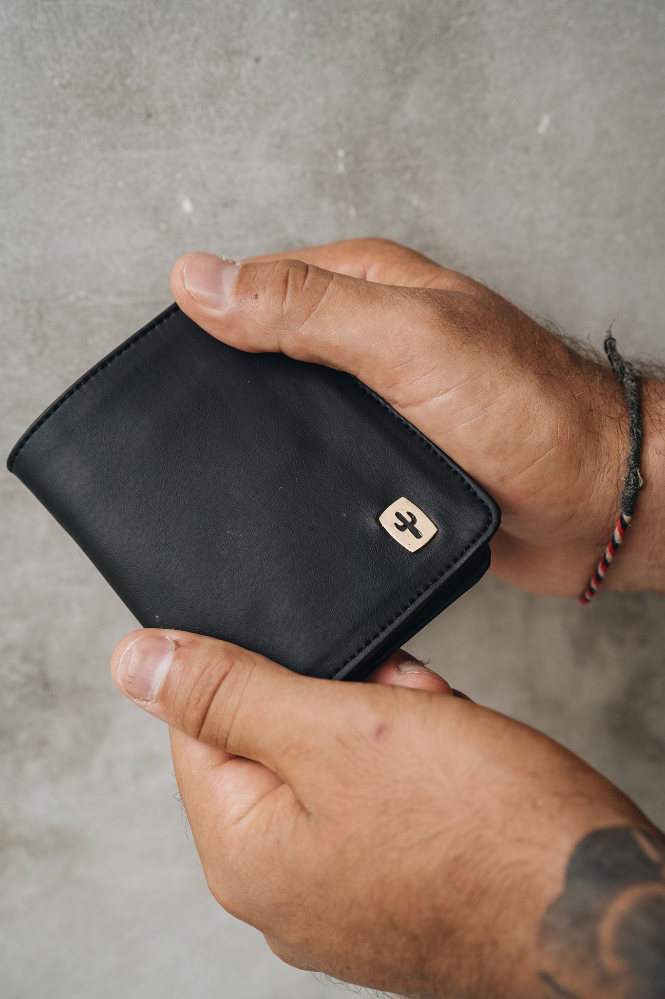 Vegan leather wallet front with Cactus logo made from brass